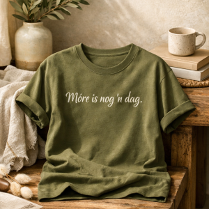 Olive t-shirt with white print written, "More is nog n dag".
